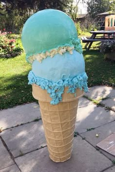 an ice cream cone with blue frosting on top