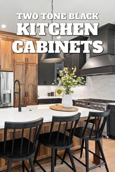 two tone black kitchen cabinets with white countertops and wooden chairs in the center island