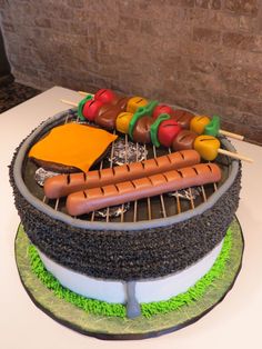 a cake with hot dogs and cheese on it