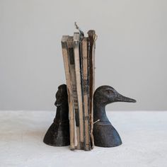 an old book with two ducks sitting next to each other on top of a table