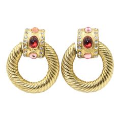 pair of gold tone earrings with red and white stones