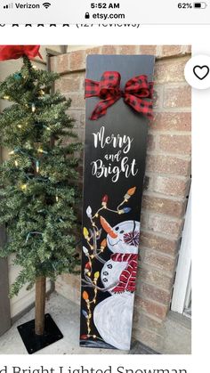 a christmas tree next to a sign that says merry and bright