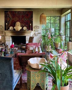 a living room filled with lots of furniture and plants