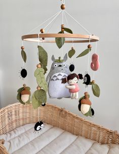 a baby crib with an animal mobile hanging from it's side