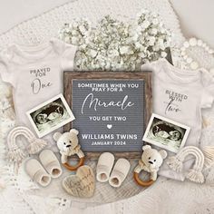 baby announcement with teddy bears, shoes and other items on a lace doily next to flowers