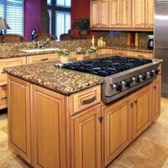 a kitchen with granite counter tops and wooden cabinets