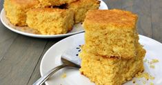 two plates with pieces of cornbread on them and one plate has a fork in it