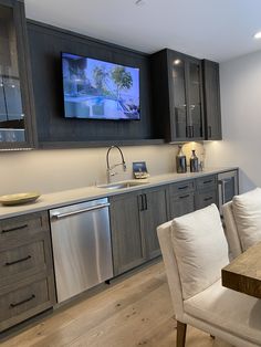 a kitchen with a large flat screen tv on the wall