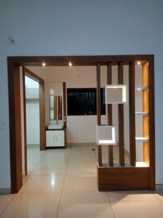 an empty room with white tile and wooden accents