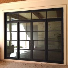 an empty room with glass sliding doors on the outside