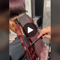 a woman is cutting her hair with scissors