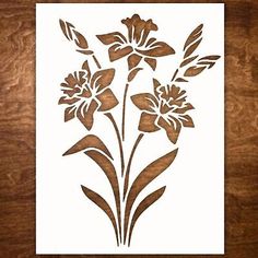 an image of flowers on a wooden table with white paper in the middle and brown wood grain