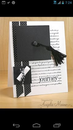 a black and white graduation card with a tassel