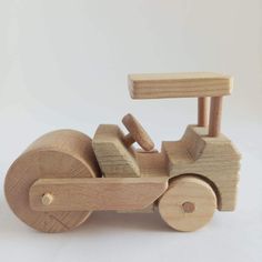 a wooden toy car with wheels on a white background