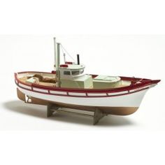 a toy boat is shown on a white surface with red trimmings and wheels