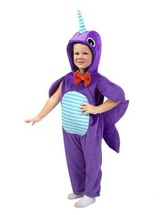 a little boy dressed in a purple costume