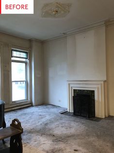 an empty living room with a fireplace and no one in the house or someone else