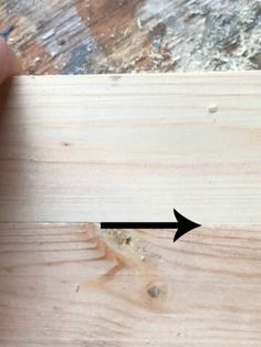 a piece of wood with an arrow pointing to it