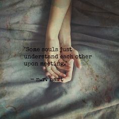 two hands holding each other on top of a bed with the words, some soul's just understand and each other upon meeting