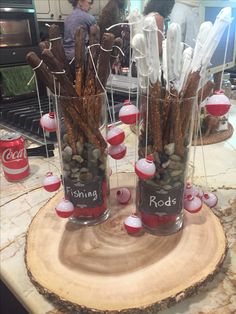 two glass vases filled with food on top of a wooden slab in a kitchen