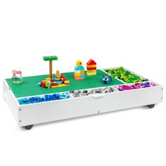 a toy table with legos and toys in it on a white background for display