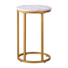 a white marble top side table with gold metal frame and round base, against a white background