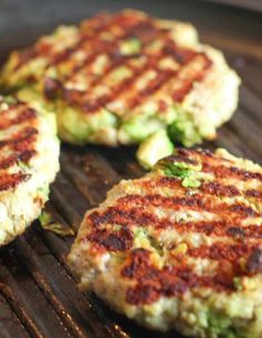 three burgers cooking on a grill with the words chicken avocado burgers