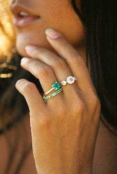 a close up of a person with a ring on their finger and her hand near her face