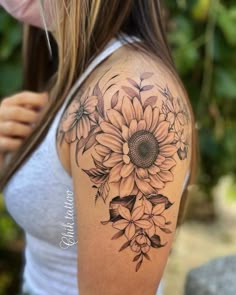 a woman with a sunflower tattoo on her shoulder