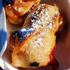 powdered sugar covered pastries in a paper container