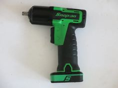 a green and black cordless drill on a white background with the word snap'n