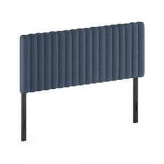 an upholstered headboard with black legs and a dark blue fabric cover on it