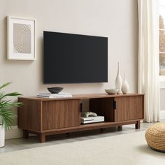 a flat screen tv mounted to the side of a wooden entertainment center in a living room