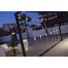 an outdoor patio with lights and chairs