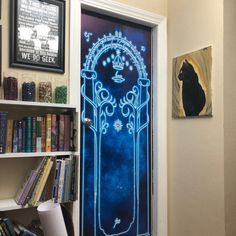 a blue door with an image of a cat on it in front of bookshelves