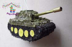 a pinata shaped like a tank hanging from a wall