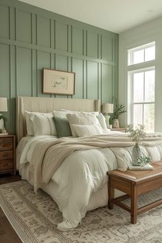 a large bed sitting next to a window in a room with green paint on the walls