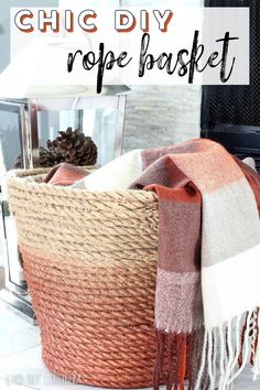 a basket with a blanket on top of it next to a lamp and fire place