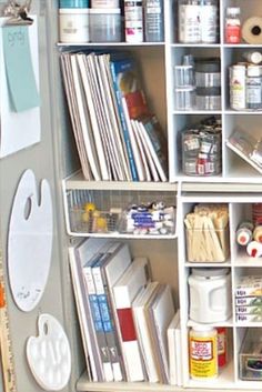 interior of a storage cabinet with custom shelves. the focus is on two large sections that are tall rectangles and have lots of artist canvas and sketchbooks on each shelf, inserted like books and leaning on each other slightly. the rest of the cabinet has many other smaller shelves with other types of artist materials. Portable Art Supply Storage, How To Store Canvases, Art Class Storage Room Organization, How To Store Art Supplies, Arts And Craft Storage Ideas, Canvas Storage Ideas, How To Organize Art Supplies, Paint Tube Organization, Sketchbook Storage