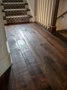 a wooden floor in front of some stairs