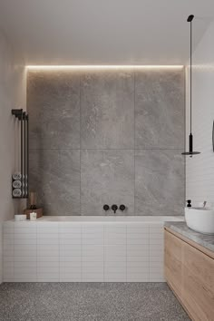 a bathroom with a tub, sink and mirror next to the bathtub is illuminated by lights