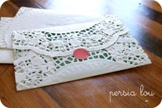 two white doily bags sitting on top of a wooden floor