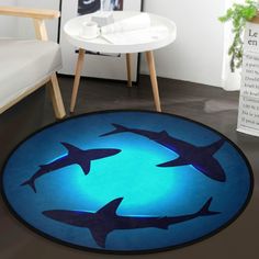 three sharks swimming in the ocean on a circular rug