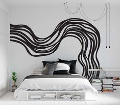 a bedroom with black and white decor on the wall