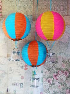 three colorful paper lanterns hanging from the ceiling