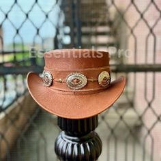 Introducing the Handcrafted Distressed Brown Leather Top Hat, a bold and unique accessory that combines Western, Steampunk, and Gothic influences in one striking design. Perfect for men who enjoy a rugged yet stylish look, this hat is ideal for anyone seeking a unique gift for him. Whether for special occasions, cosplay, or everyday fashion, this handcrafted top hat delivers on both quality and style. Product Description: Made from high-quality distressed brown leather, this top hat is meticulou Steampunk Mode, Leather Top Hat, Brown Leather Top, Steampunk Hat, Unique Gifts For Him, Unique Gifts For Men, Steampunk Design, Handcrafted Accessories, Western Hats