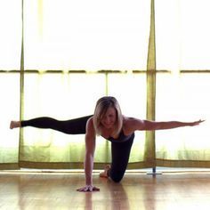 a woman is doing yoga on the floor