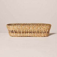 a wicker basket sitting on top of a white table