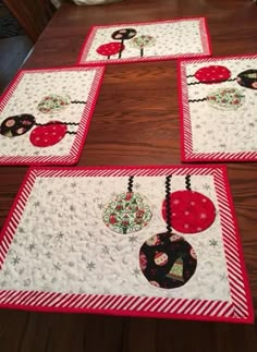 four quilted placemats with ladybugs and snowflakes on them