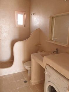 a washer and dryer in a small bathroom